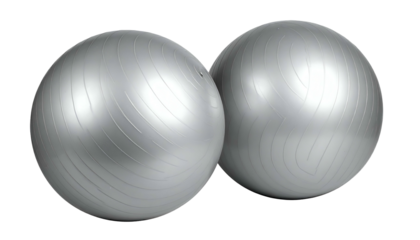 Two silver exercise balls, side-by-side, reflecting light on black backdrop