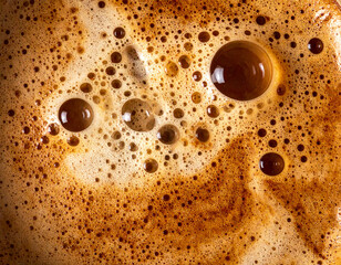 Close-up macro shot of coffee bubbles and foam texture