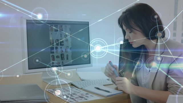 Animation of connected dots and lens flares over caucasian woman shortlisting models portfolios