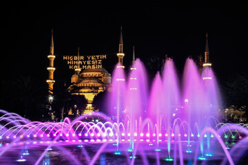 night view of blue mosque and it is written No orphan should be left without protection.