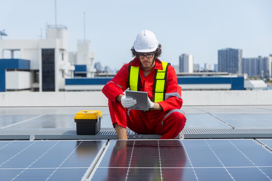 Engineers analyzing rooftop solar panel system data - Powered by Adobe