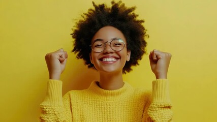 A smiling individual with raised fists conveys a sense of triumph and accomplishment.