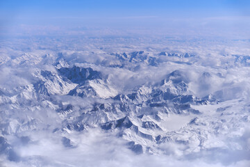 Caucasus mountains with snow peaks in aerial winter scene. Aerial view from plane.