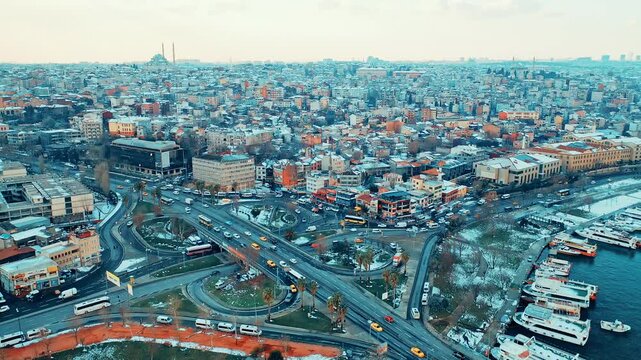 Istanbul Unkapani aerial view of Ataturk Bridge and traffic toward Eminonu and Balat. Cinematic drone flight over the snowy city and Golden Horn.