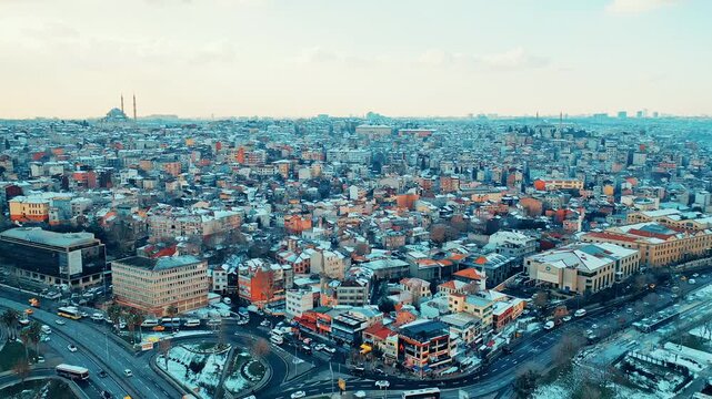 Istanbul Unkapani aerial view of Ataturk Bridge and traffic toward Eminonu and Balat. Cinematic drone flight over the snowy city and Golden Horn.