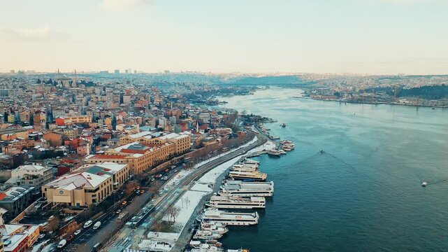 Balat aerial view of colorful historic houses covered in white snow. Cinematic drone flight over the snowy old town and winter landscape in Istanbul.