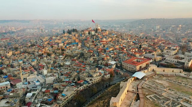 Gaziantep Castle aerial view of the historic stone fortress and city walls. Cinematic drone footage of the ancient landmark in Turkey at daytime.