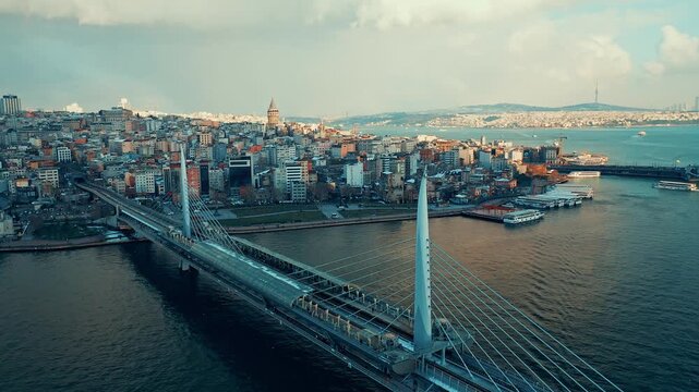 Halic Metro Bridge aerial view of the modern transit bridge over Golden Horn. Cinematic drone flight showing the metro station and Istanbul skyline.