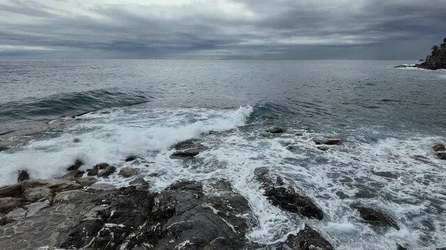 Ocean waves crashing on coastal rocks in Bogliasco Italy.