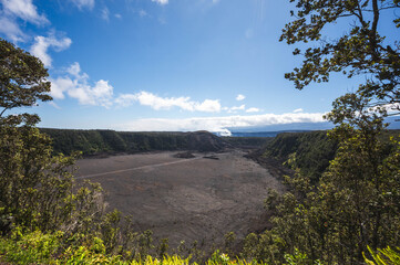 Volcanic crater with solidified lava lake and surrounding rainforest viewed from overlook on Big Island Hawaii © EyesTravelling