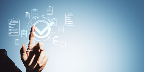 Business hand interacting with digital check mark and checklist icons in a conceptual user interface on blue gradient background for quality control.