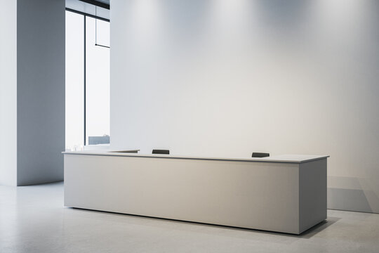Modern minimalist reception desk mockup in bright office interior with large blank wall for branding or logo placement. 3D Rendering