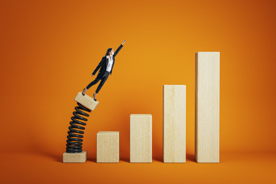 Businesswoman launching from springboard on wooden bar chart symbolizing career growth and success on vibrant orange background.