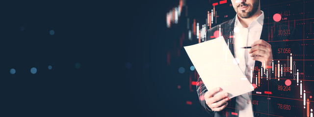 Businessman analyzing financial data on paper with stock market candlestick chart overlay on dark background for investment and finance concept.