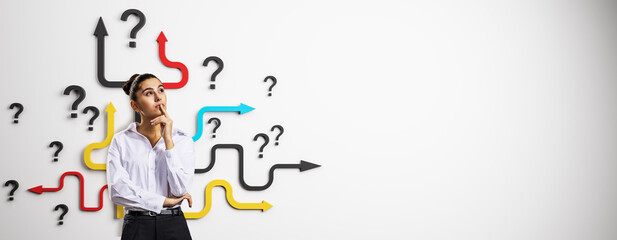 Thoughtful woman standing in front of colorful arrows and question marks symbolizing decision making and uncertainty on white background.