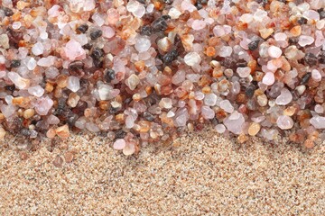 Close Up of Rose Quartz Gravel Bordering Sand in Warm Light