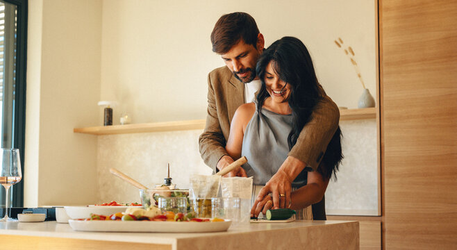 Couple preparing a meal together in a modern kitchen