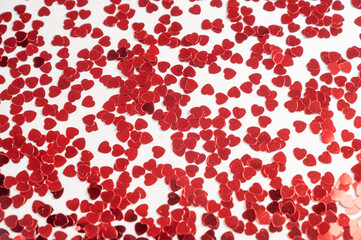 Hearts sequins on a white background, flat lay top view