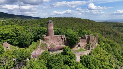 Forgotten castle ruins in forest landscape with autumn colors