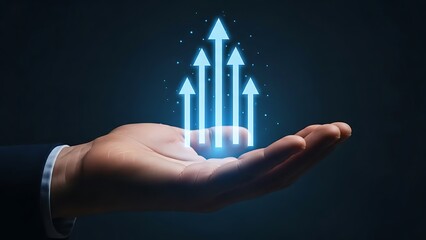 Business hand holding bright glowing blue upward pointing arrows in dark background concept