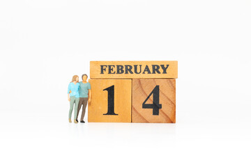 Miniature Couple Standing Beside February 14 Valentine&rsquo;s Day Calendar Blocks
