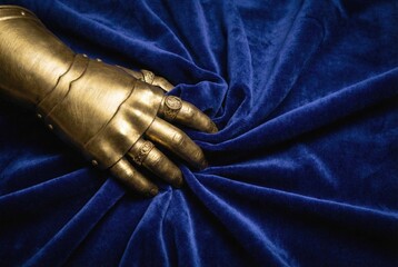 Golden gauntlet representing power and authority on velvet