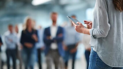 Focused medium shot of a consultant presenting a strategic philanthropy plan on a digital tablet to attentive clients.