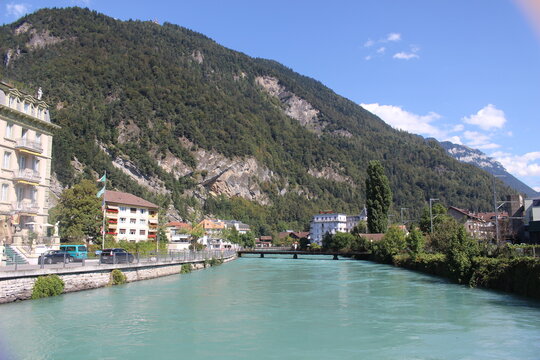 Beautiful panoramic view of the turquoise Aare River flowing through Interlaken with bridges and riverside buildings
