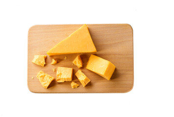 piece of cheddar cheese on a cutting board isolated on a white background.