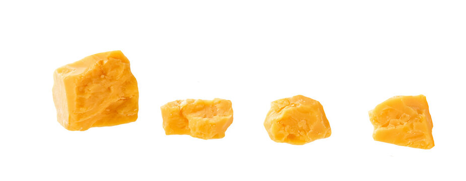 cheddar cheese cubes isolated on a white background. aged cheddar cheese .