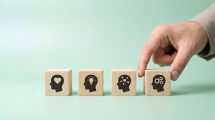 Fototapeta na wymiar hand arranging wooden blocks with human head and brain icons