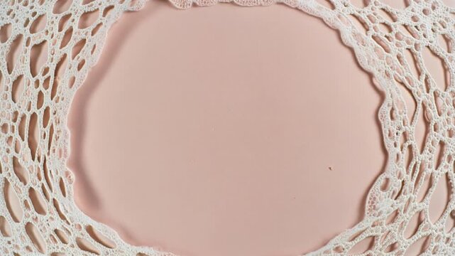 White foam pattern flowing on a soft pink surface
