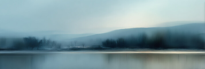 Fototapeta premium Evocative misty morning panorama showcasing an impressionistic tableau of serene water reflecting hazy mountains and wispy, blurred trees, all bathed in a cool, ethereal light.