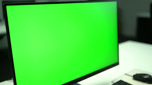 Digital Mockup Template with young man working at computer green mock up screen in office close desktop monitor chroma key display distortion, overlay, glitch, static noise, scan lines on black