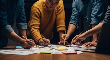 Close-up of diverse business team collaborating on financial strategy with charts and sticky notes in a dark office.