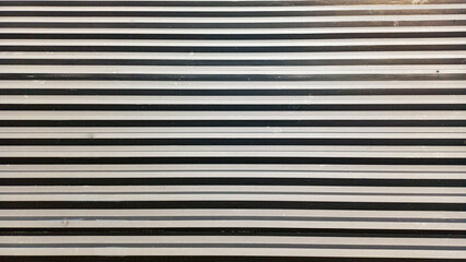 Abstract black and grey metal stripe texture. Seamless horizontal line pattern from industrial building cladding. Modern metallic background for graphic design and web.