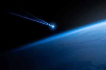 Comet, asteroid, meteorite flying to the planet Earth.  Glowing asteroid and tail of a falling comet threatening the safety of the Earth.  Elements of this image furnished by NASA.