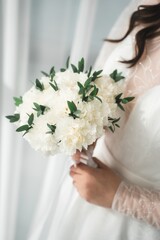 Close up of the bride's hands holding a bouquet of flowers. Bridal bouquet, hold the wedding bouquet in your hand