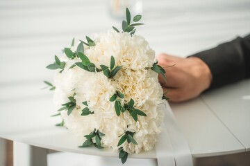 Close up of the bride's hands holding a bouquet of flowers. Bridal bouquet, hold the wedding bouquet in your hand