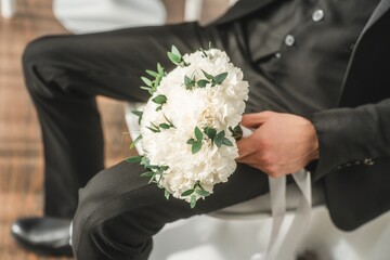 Close up of the bride's hands holding a bouquet of flowers. Bridal bouquet, hold the wedding bouquet in your hand