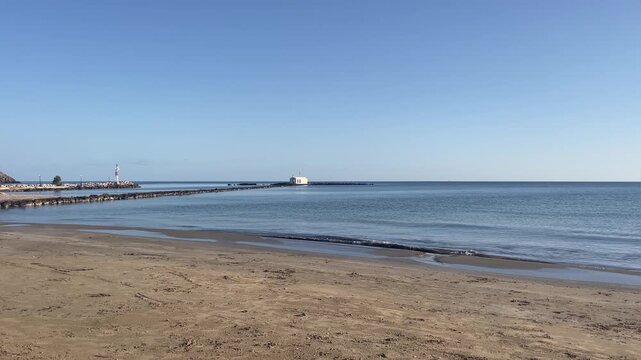 Horizontal view of Agios Nikolaos Church in Georgioupoli, white chapel in the sea, calm water and sunny weather, Crete
