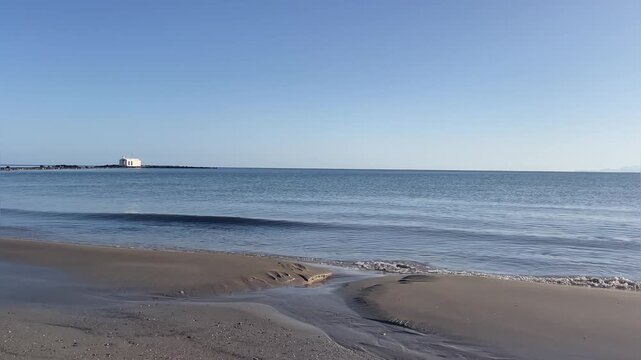 Horizontal view of Agios Nikolaos Church in Georgioupoli, white chapel in the sea, calm water and sunny weather, Crete