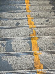 Distressed Granite Outdoor Stairs with Fading Yellow Safety Line