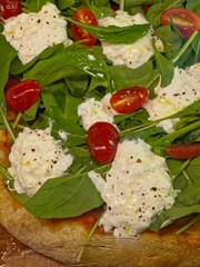 Fresh Burrata and Arugula Pizza with Cherry Tomatoes. Close up Vertical Image.