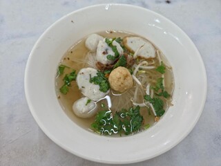 Top-down View of Asian Fishball Noodle Soup in White Bowl.