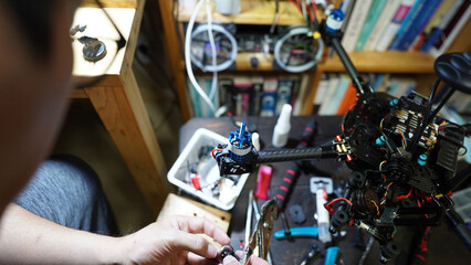Close-up of a technician’s hands repairing machinery with tools and components.