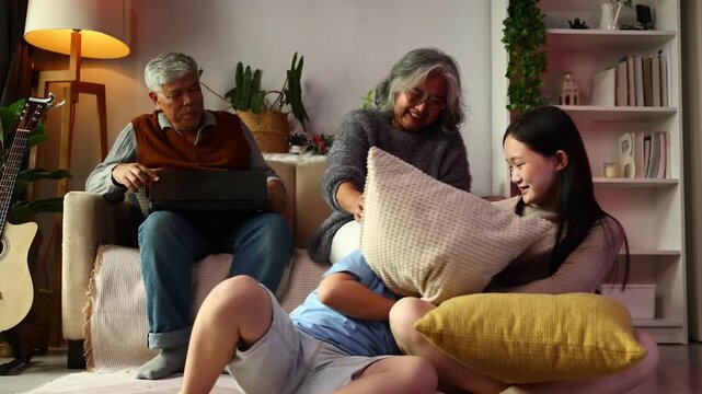 teasing. sisters and brothers are having fun teasing each other. Asian sibling having fun playing game. Happy Family leisure activity with parents and children playing video game living room at home