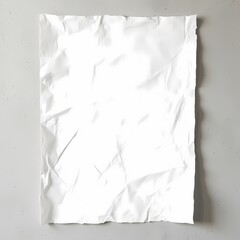 Crumpled white paper on a gray surface creating a textured background