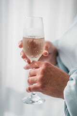 women's hand holding a glass of champagne close up