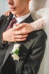Details of bride and groom hugging at wedding day